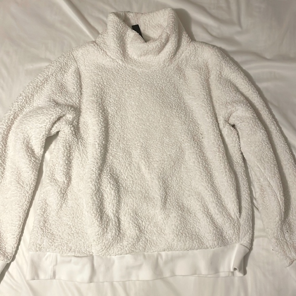 A fluffy sweatshirt. No stains extremely comfy has pockets. turtleneck.